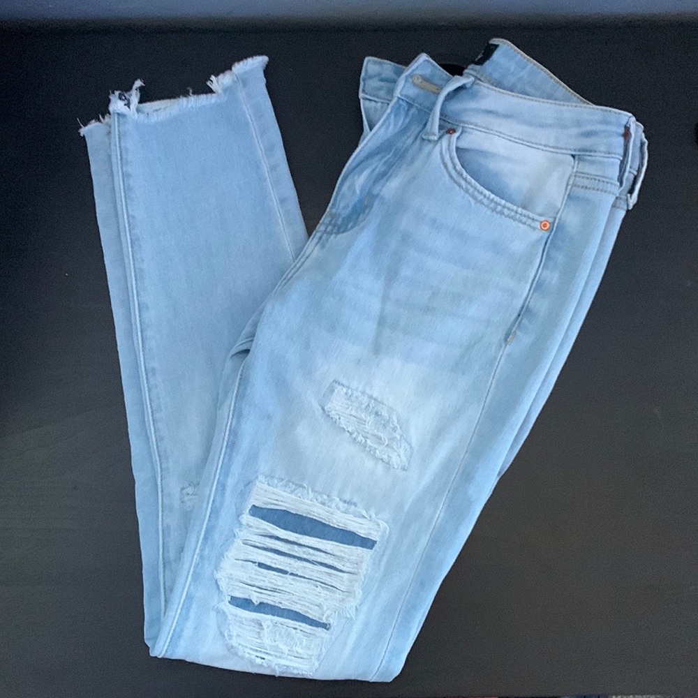 Light blue wash covered ripped skinny jeans